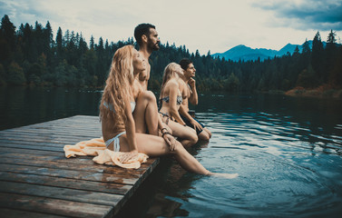 Group of friends having fun at the lake in the morning