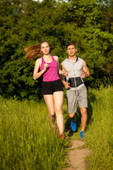 Active young couple running in the park