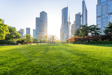 green lawn with modern office building - obrazy, fototapety, plakaty