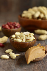 Obraz na płótnie Canvas Assortment of peanut in a wooden bowls and peanut butter.