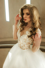 Beautiful bride with fashion wedding hairstyle. Bride at wedding in white wedding dress and veil. Luxurious wedding.