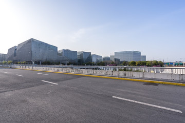 empty asphalt road with modern office building