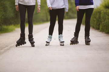 Close-up view of group of female legs on roller skates