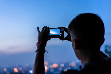young man take photo with smartphone