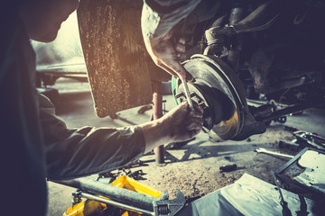 technician working on checking and service car in  workshop garage; technician repair and maintenance engine of automobile in car service