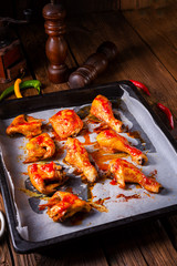 Rustic backed chicken wings,legs on baking tray