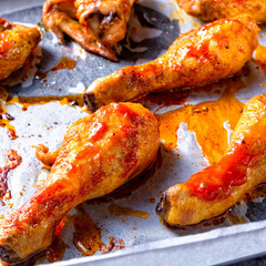 Rustic backed chicken wings,legs on baking tray