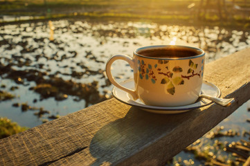 hot coffee put on top wooden in morning time