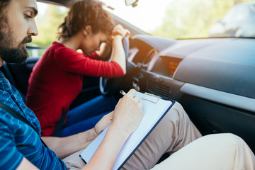 Driving school. Stressed and disapointed young woman failed on driving test.