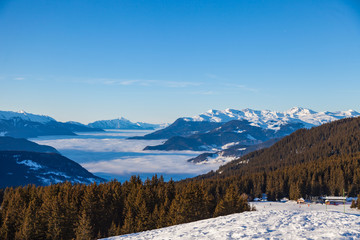 Fototapeta na wymiar Clouds in valley. Ski resort Les Trois Vallees, winter 2018, France