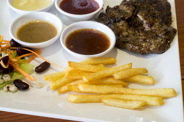 Grilled steak with vegetables on white dish