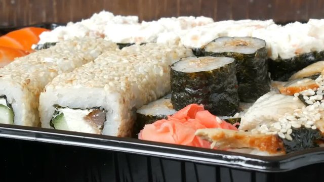 A lot of different Nigiri Gunkan Maki Sushi with eel salmon Philadelphia cheese cucumber close up view