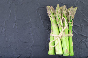 Fresh green asparagus on dark background