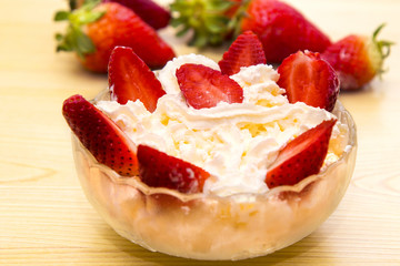 glass bowl of strawberries with cream