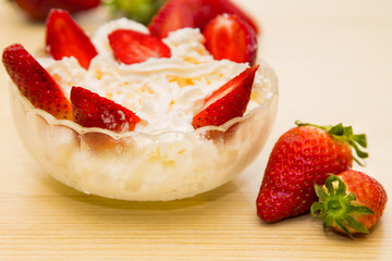 glass bowl of strawberries with cream