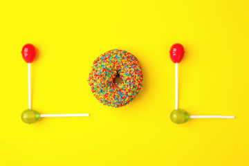 Word lol from sweetness on yellow background. Abbreviation stands for laugh out loud, flat lay trendy background