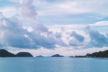 Morning Harbor with views of mountains and clouds.