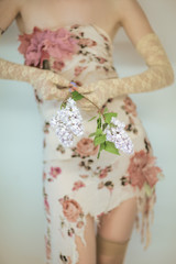 Woman hands holding fresh violet lilac flowers, sensual rural studio shot can be used as background 