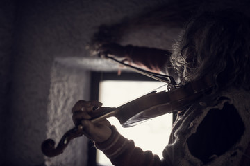 Retro toned  image of and older man playing violin