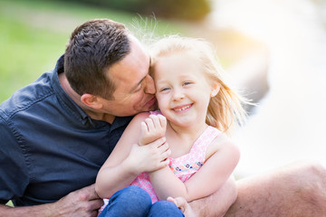 Fototapeta premium Young Caucasian Father and Daughter Having Fun At The Park