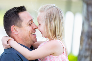 Fototapeta premium Young Caucasian Father and Daughter Having Fun At The Park