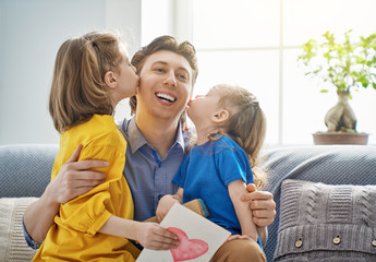 daughters congratulating dad