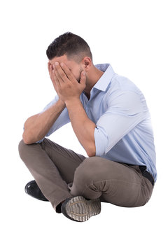 sad man covers his face