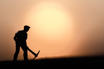 Abstract,silhouette people mining on sky sunset background.