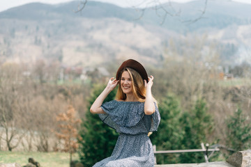 Fototapeta premium The girl in a hat dreams on the nature