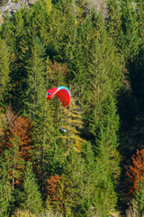 An athlete on a paraglider landing after a jump, Bernese Highlands, Switzerland