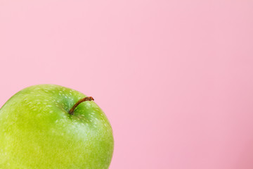 part of green Apple on pink background