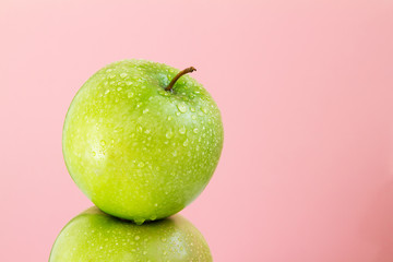 part of green Apple on pink background