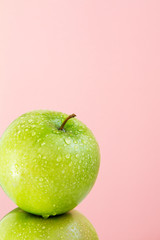 part of green Apple on pink background