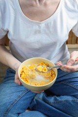 corn flakes in a bowl in hands