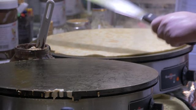Hands preparing crepes 