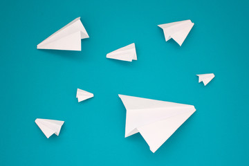 White paper planes on a blue background. Telegram symbol