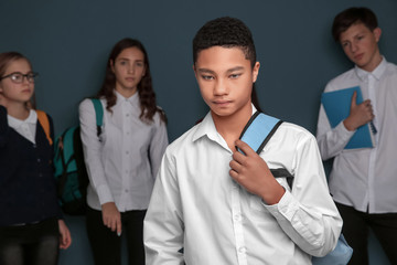 Teens bullying their African American classmate indoors