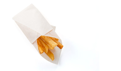 French fries in a gift wrapping on a white background (close top view)
