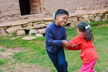 Happy latin kids playing in the countryside.