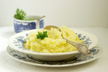 Appetizing mashed potatoes with butter and parsley. Rustic style.