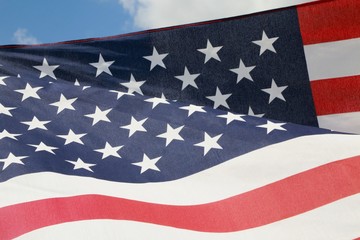 American Flag Fluttering in the Breeze in a Sunny Morning against Partly Cloudy Sky
