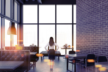 Luxury brick restaurant interior, businesswoman