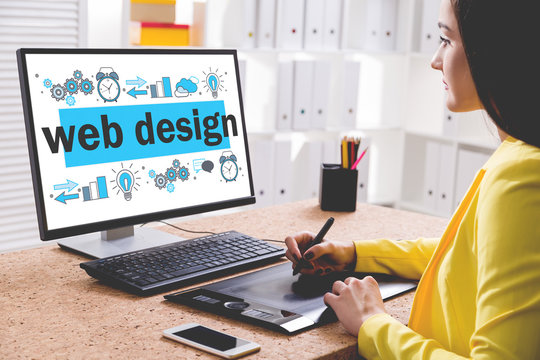 Attractive designer drawing a web design sketch
