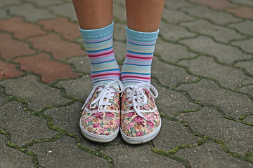 A view of young girl legs with socks and sport shoes, 