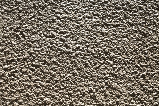 Gray Cement House Wall Ridges Up Close in the Afternoon Sun