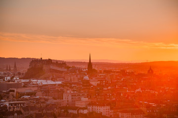 Edinburgh cityscape with Edinburgh Castle in background at sunset as viewed from the Ethe Arthurs Seat hill, Scotland, UK