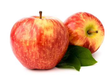 Two ripe red apples with leaves on a white. isolated.