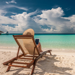 Young woman with tablet pc at the beach