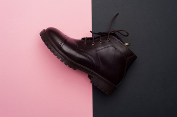 Dark brown man shoes on colorful background. Flat lay, top view