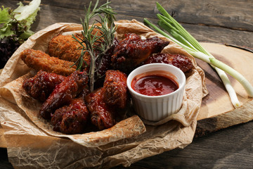 skewers of beef and chicken with sauce and pita bread on a wooden plate